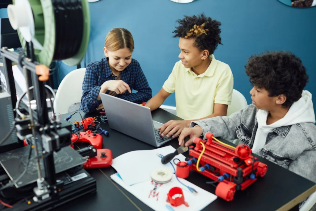 Three kids working on a 3D project together